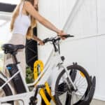 woman putting a bike in a Velo floor mount rack