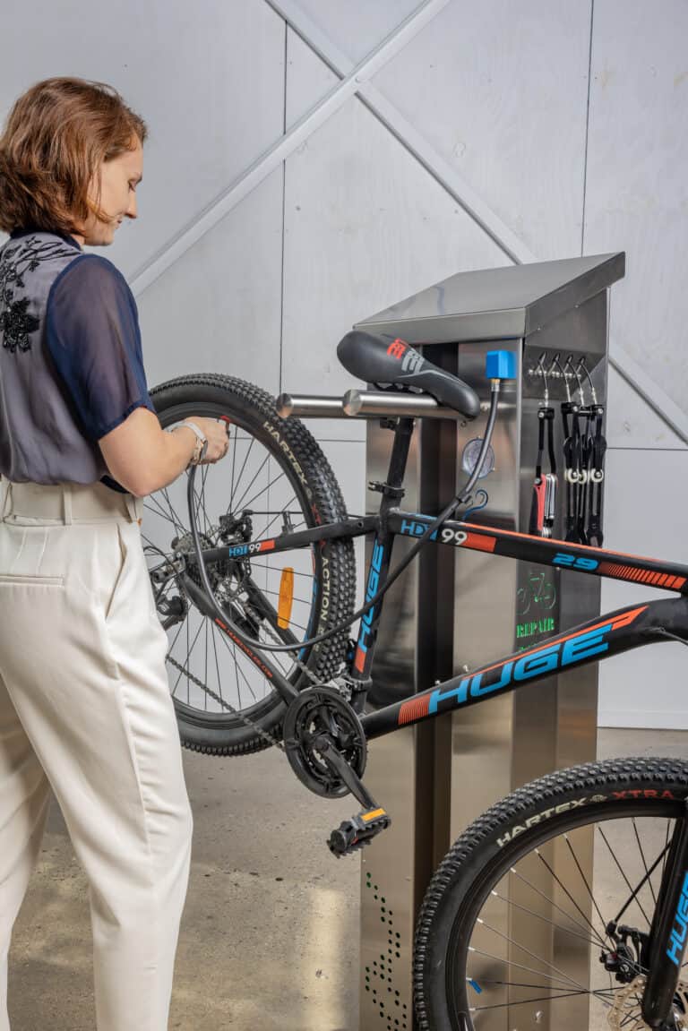 Woman using a bike repair station