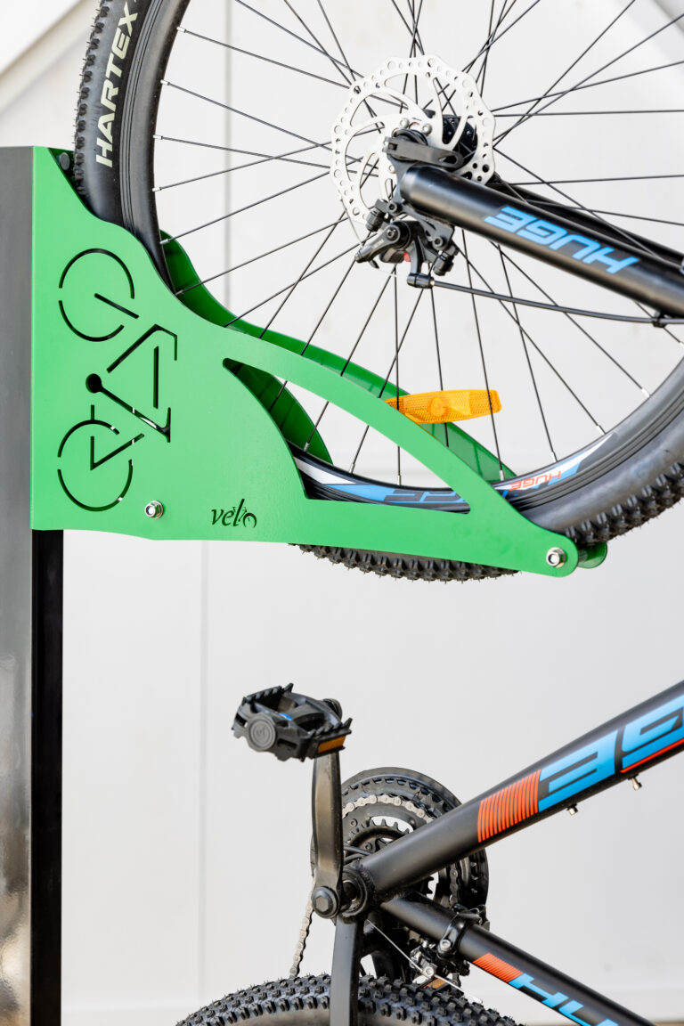 Green vertical bike rack with bike stored on rack