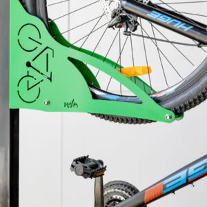 Green vertical bike rack with bike stored on rack